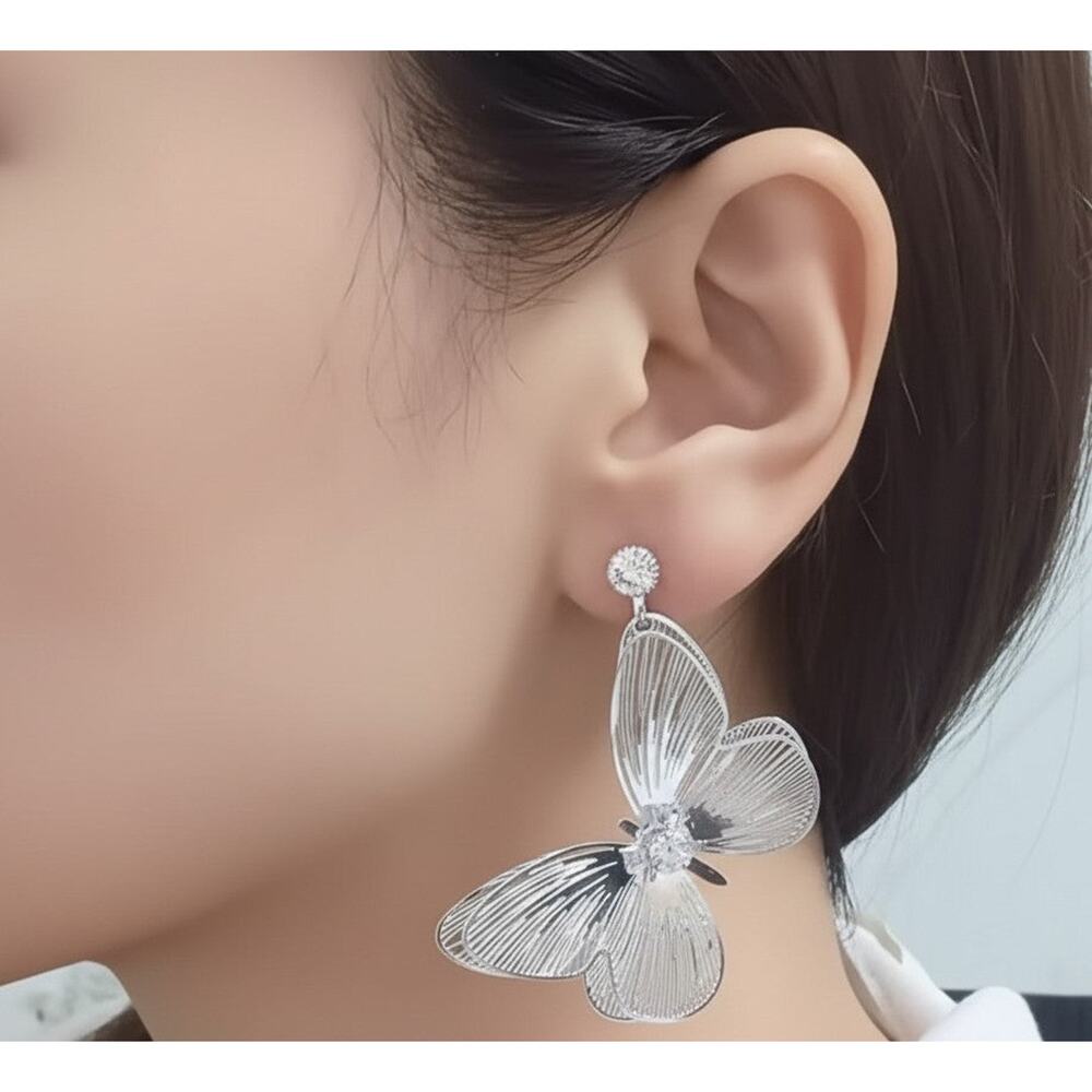 Clip on 2 1/2" silver cutout dangle butterfly earrings with clear stone